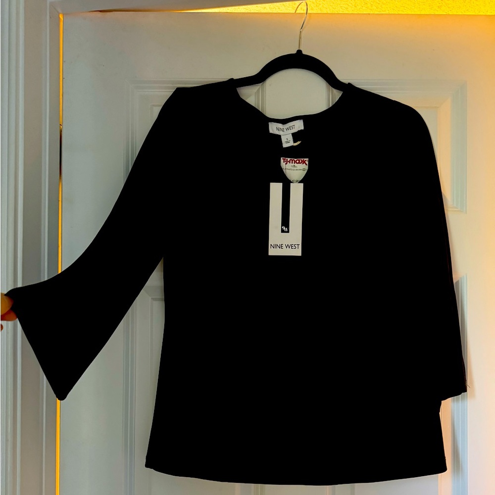 Black Nine West long sleeve top with silver ring accent on chest. NWT.